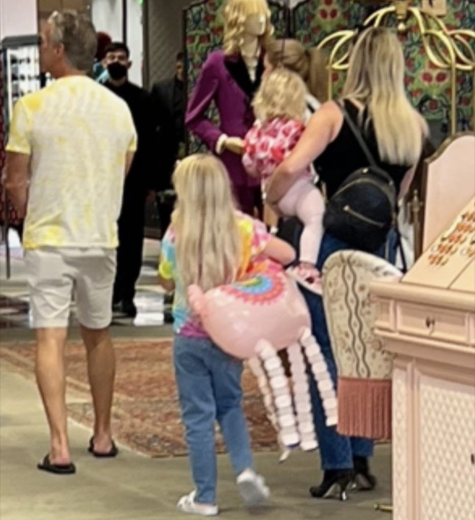 man, woman and children shopping