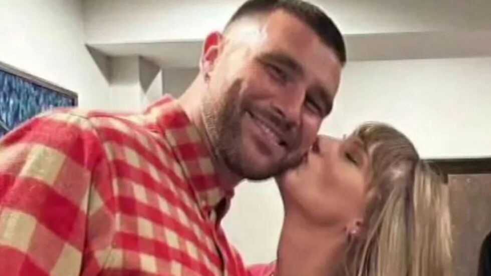 Taylor Swift kissing Travis Kelce on the cheek