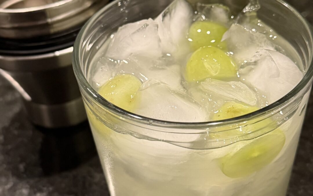 photo of a lowball cocktail glass with a grape crush cocktail