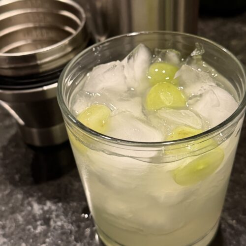 photo of a lowball cocktail glass with a grape crush cocktail
